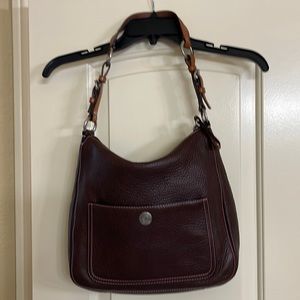 Chocolate brown leather coach bag with pink stitching. Perfect pink interior.